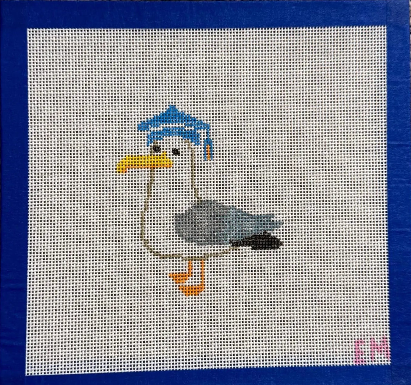 needlepoint  seagull with a blue cap 