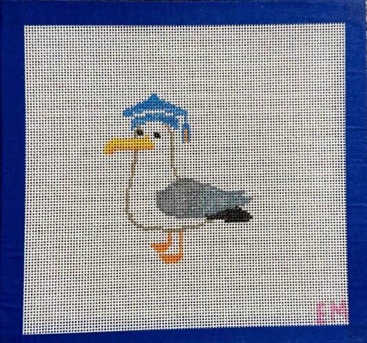 needlepoint  seagull with a blue cap 
